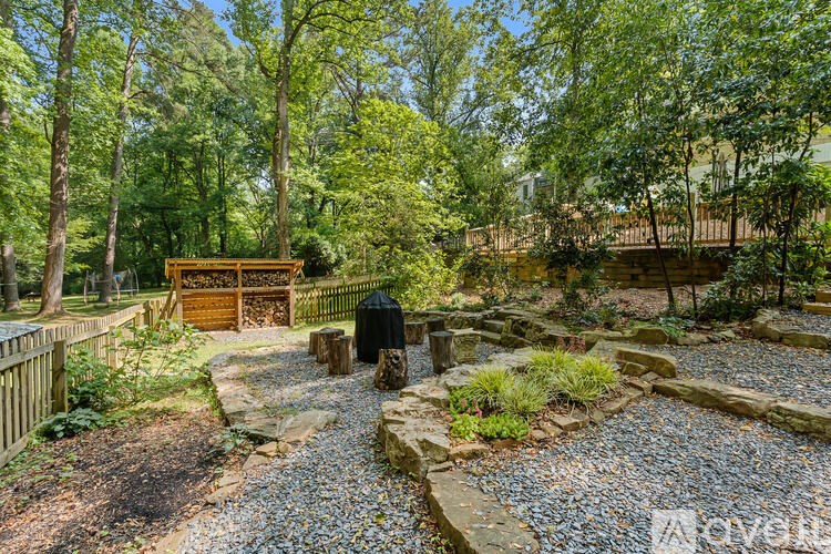 A garden with a wooden bench and a gravel path.