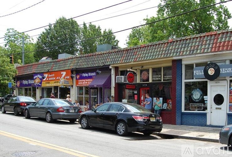 Cars parked in front of a store with a sign that says "FULLY RECORDED".