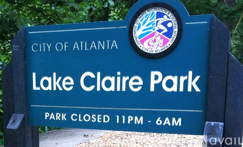 A sign for Lake Claire Park in the City of Atlanta indicating that the park is closed from 11 PM to 6 AM.