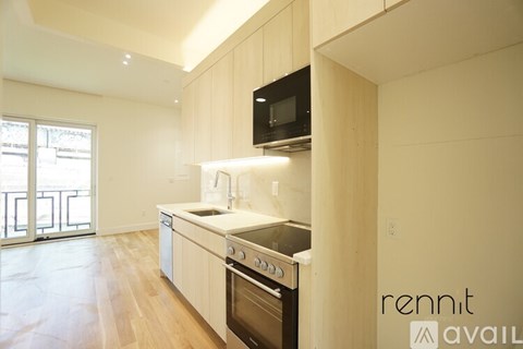 A kitchen with a stove top oven and microwave.