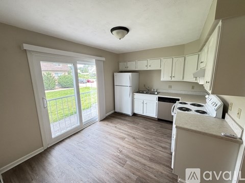 A kitchen with white appliances and cabinets is available for rent.