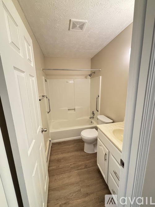 A small bathroom with a toilet, sink, and bathtub.