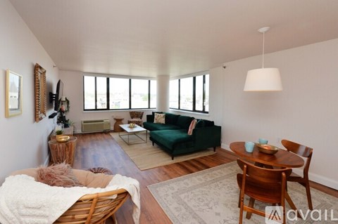 A living room with a green couch and a wooden table.