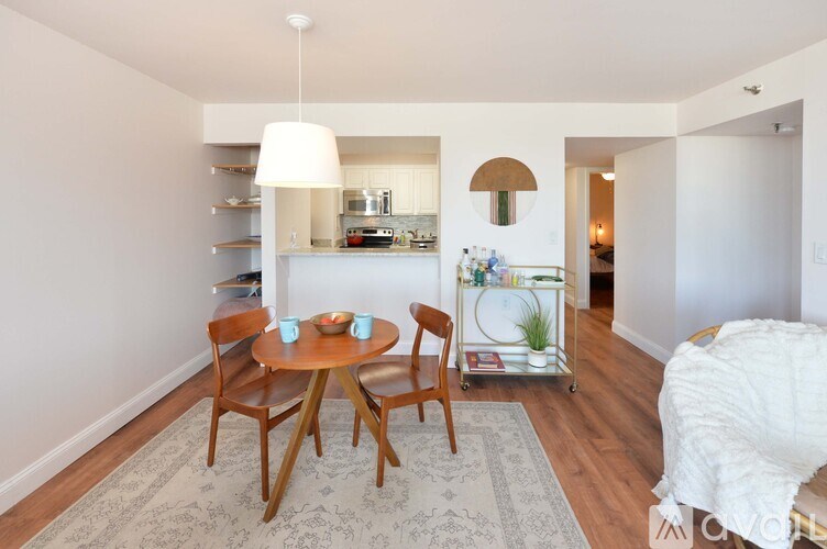 A dining room with a table and chairs.