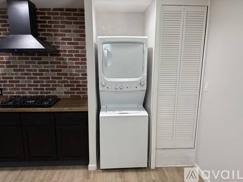 A white microwave oven is placed on a kitchen counter.