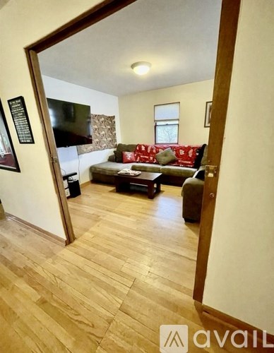 A living room with a couch and a television.