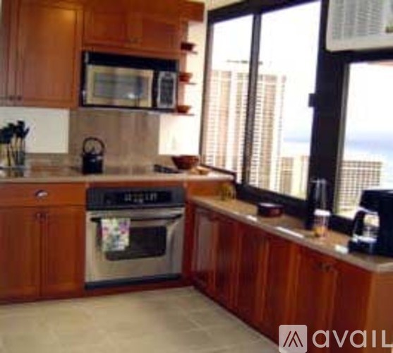 A kitchen with wooden cabinets and a stainless steel oven.