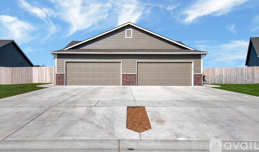 A house with a garage and a driveway in front.