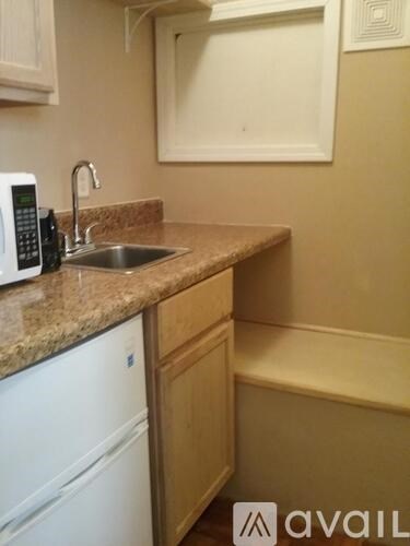 A kitchen with a sink and a dishwasher.