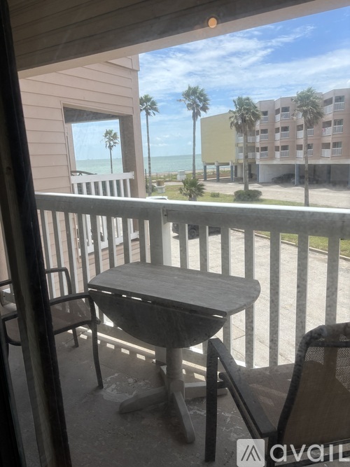 A room with a table and chairs and a window with blinds.