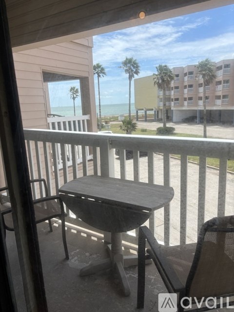 A room with a table and chairs and a window with blinds.
