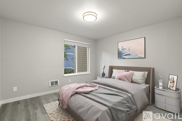 A bedroom with a large bed and a painting on the wall.