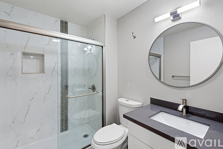 A bathroom with a marble toilet and sink.