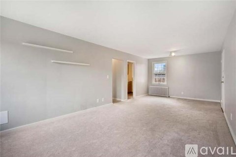 A spacious empty room with a door and a window.