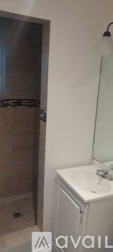 A bathroom with a white sink and a mirror.