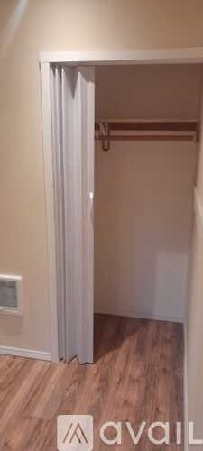 A room with a wooden floor and a white door.