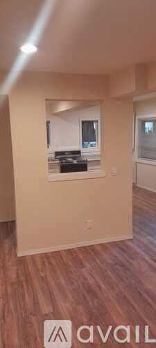 A room with wooden flooring and a window.