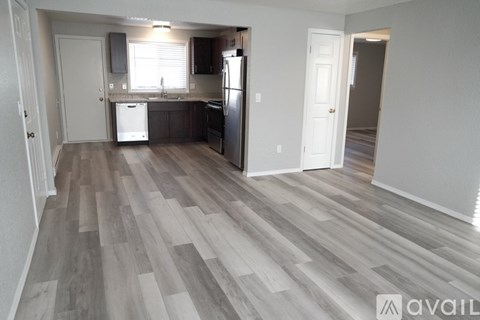 A kitchen with a refrigerator, sink, and dishwasher.