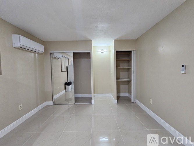 A spacious room with a tiled floor and a walk-in closet.