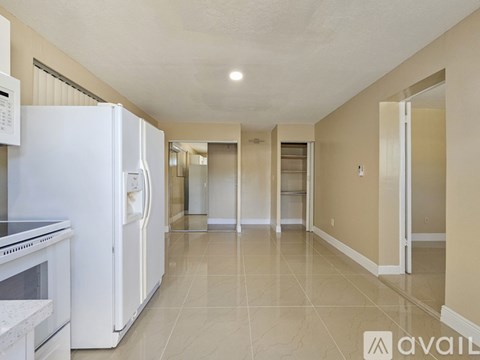 A kitchen with a white refrigerator and a white oven.