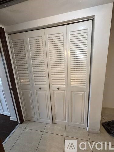 Closed white doors in a room.