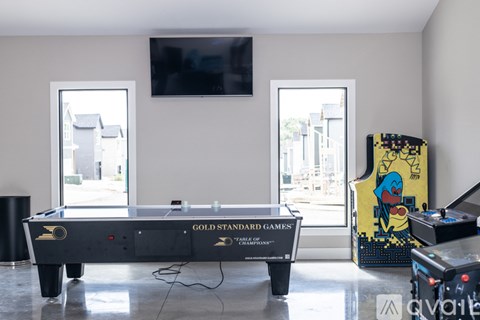 A pool table with a TV above it and a cabinet to the right.
