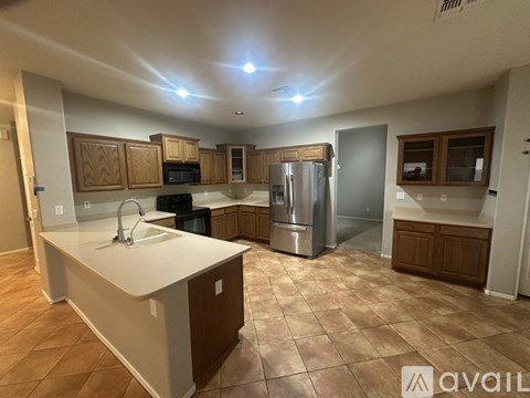 A kitchen with brown cabinets and a white countertop.