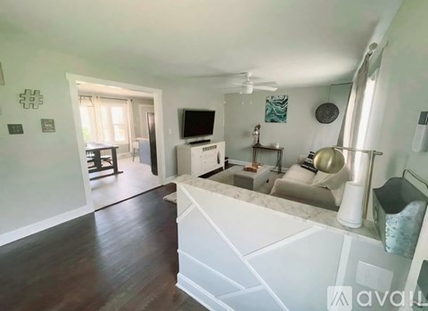 A living room with a white sofa and a television.