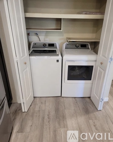 A small laundry room with a washer and dryer.
