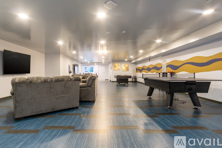 A room with a pool table and a couch.