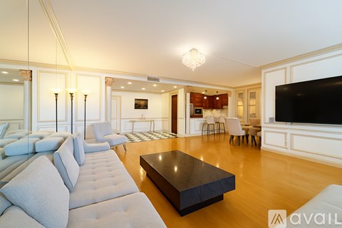 A modern living room with a large sofa and a flat screen TV.