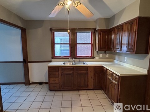 A kitchen with brown cabinets and a white countertop.
