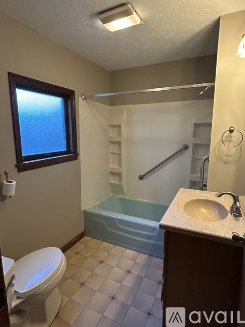 A bathroom with a toilet, sink, and bathtub.