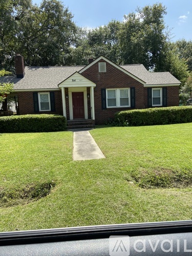A house with a red door and white trim is shown.