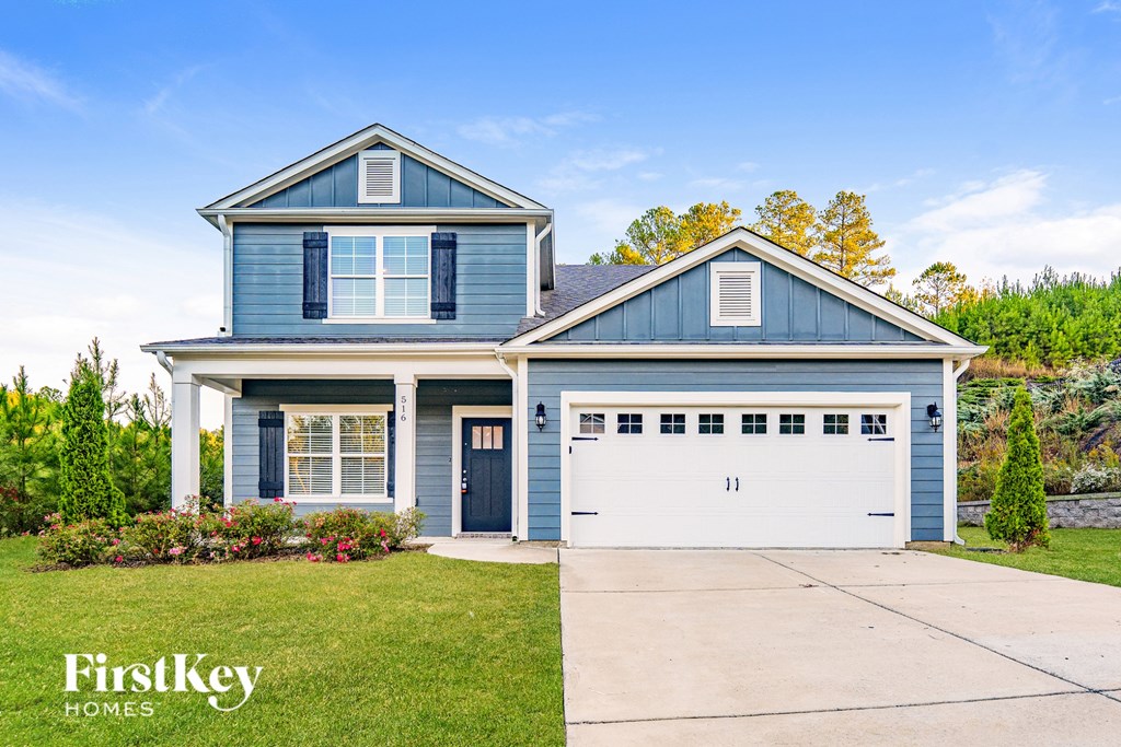 A blue house with a garage door number 11 is for sale.