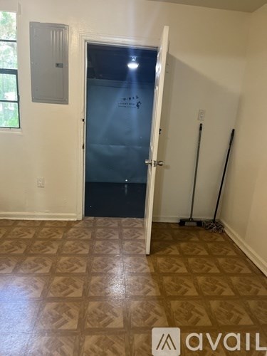 A room with a tiled floor and a door leading to a balcony.