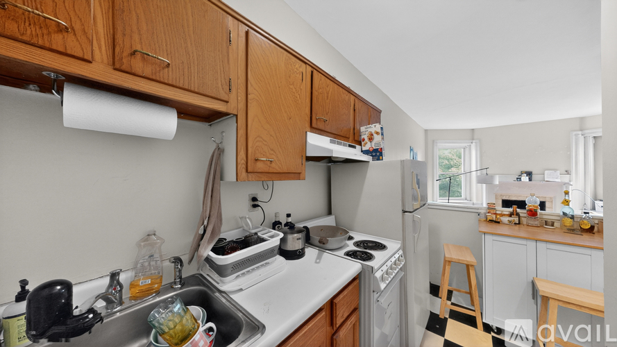 A kitchen with wooden cabinets and a white countertop.