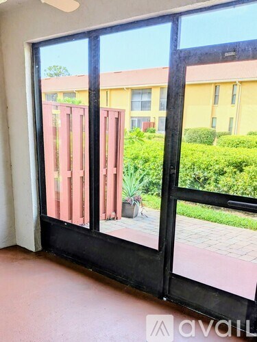 A balcony with a view of a building and greenery.