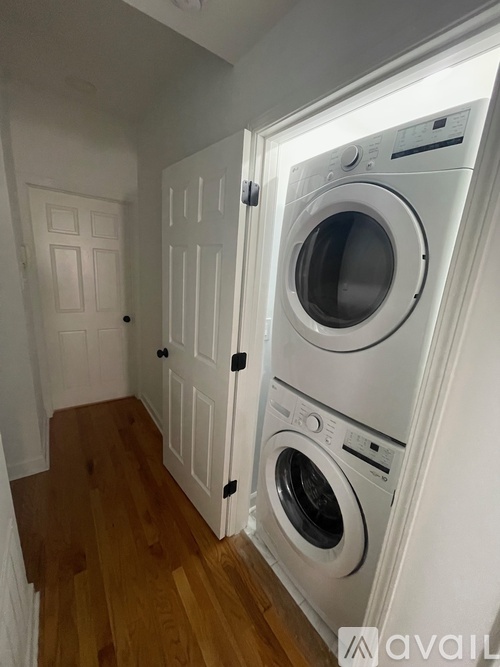 A white washing machine and dryer in a small laundry room.