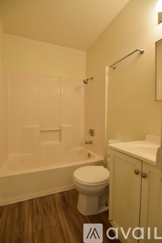 A bathroom with a toilet, sink, and bathtub.