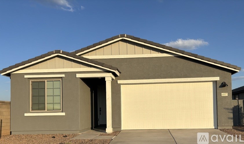 A modern house with a garage door and a window.