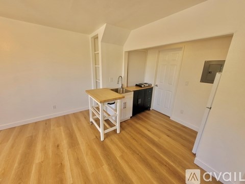 A kitchen area with a wooden table and chairs.