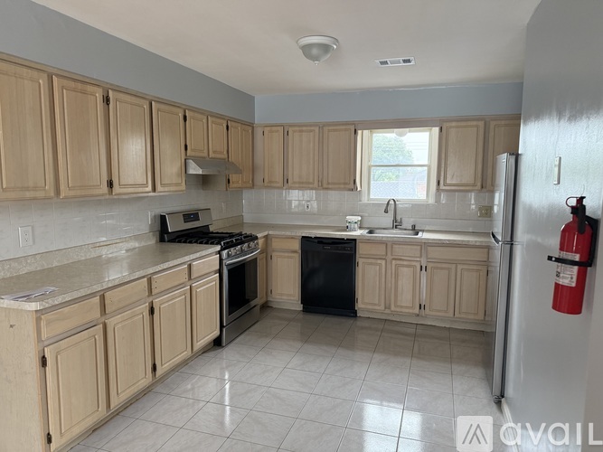 A kitchen with wooden cabinets and a white refrigerator.