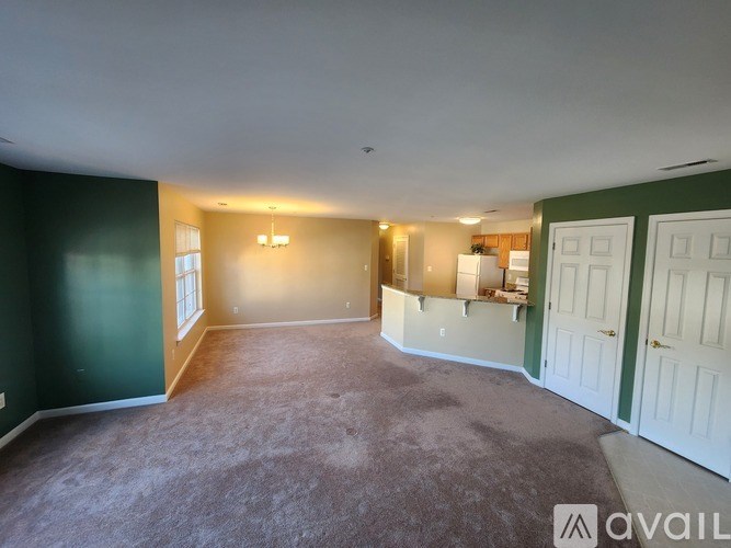 A kitchen with wooden cabinets and a tiled floor.