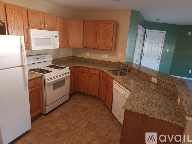 A room with a carpeted floor and a counter with boxes on it.