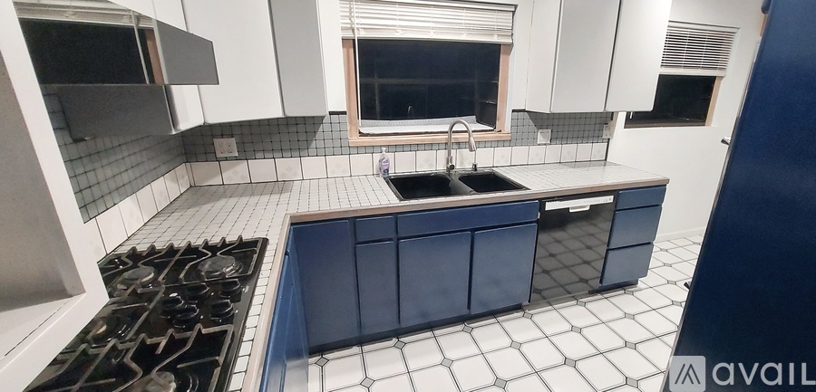 A kitchen with blue cabinets and appliances.