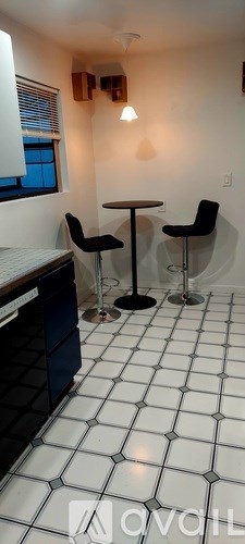 A kitchen with blue cabinets and a black sink.