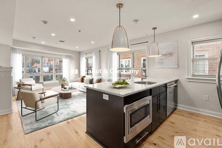 A modern kitchen with a large island and stainless steel appliances.