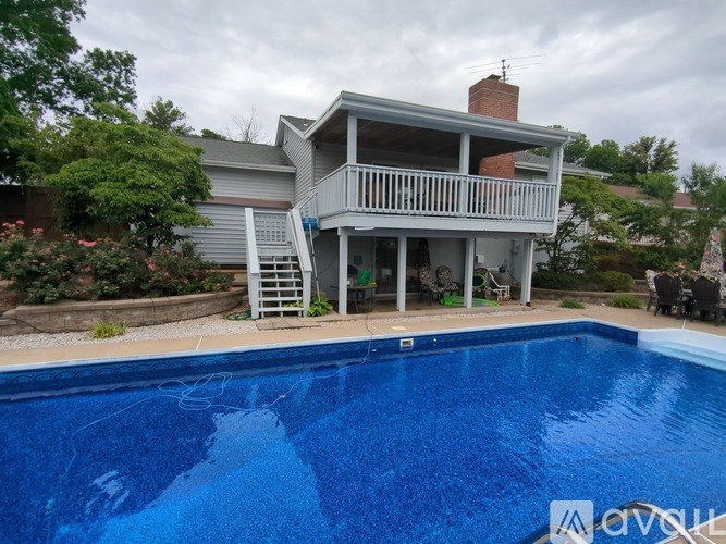A house with a pool in front of it.