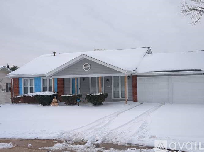 A house with a white garage door and a blue door.
